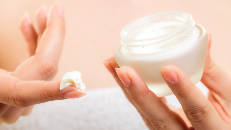 a women holding cbd topical cream product 